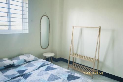 um quarto com uma cama e um espelho redondo em Nhà Tú Homestay em Thôn Mỹ Phước