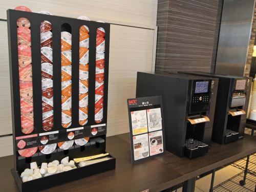 a table with a display of sushi and a vending machine at Astil Hotel Shinosaka Precious in Osaka