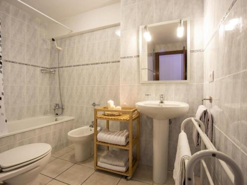 a bathroom with a sink toilet and a mirror at Casa con piscina privada a 100m de la playa, ideal para familias - HISP-288-61 in Empuriabrava