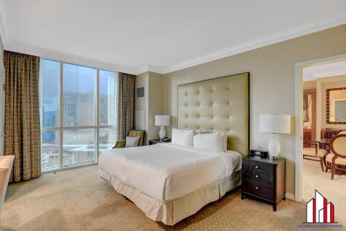 a bedroom with a large bed and a large window at MGM Signature-18-701 1Br2Ba Strip View Balcony in Las Vegas