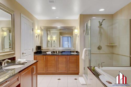 a bathroom with a tub and a sink and a shower at MGM Signature-18-701 1Br2Ba Strip View Balcony in Las Vegas