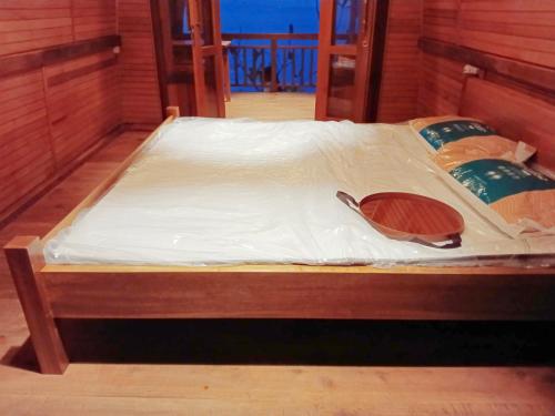 A bed or beds in a room at Bunaken 18 Diving Resort and Cafe