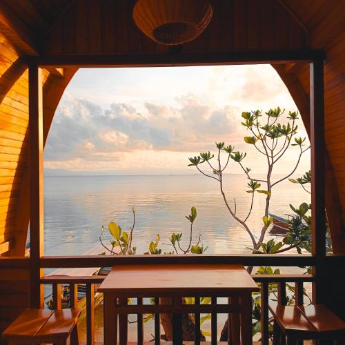 a view of the ocean from a restaurant window at Bunaken 18 Diving Resort and Cafe in Bunaken