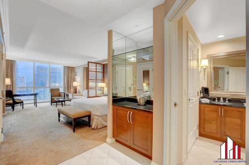 a hotel room with a bed and a bathroom at Signature 2br3ba balcony combo units 18-701 and 03 in Las Vegas
