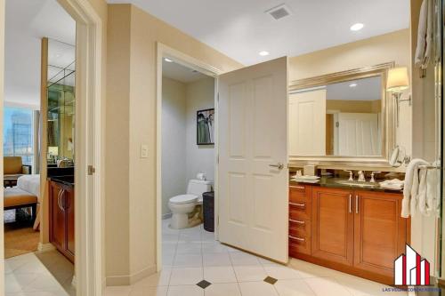 a bathroom with a sink and a toilet in it at Signature 2br3ba balcony combo units 18-701 and 03 in Las Vegas