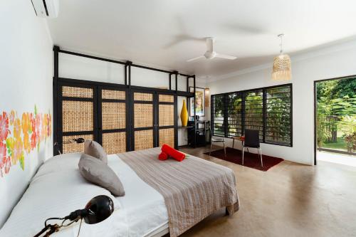 a bedroom with a bed and a desk in it at South Pacific Memories in Port Vila