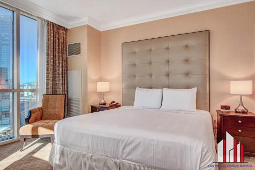 a bedroom with a large bed and a large window at MGM Signature-21-701 1Br2Ba F1 Strip View Balcony in Las Vegas