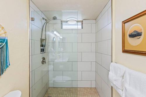 a shower with a glass door in a bathroom at Nani Kai Hale 208- Beachfront 1 bedroom 2 bathroom condo, oceanview in Kihei