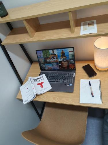 a laptop computer sitting on top of a desk at Stayonwa231-Men only in Seoul