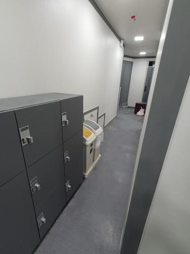 an empty room with gray cabinets and a hallway at Stayonwa231-Men only in Seoul