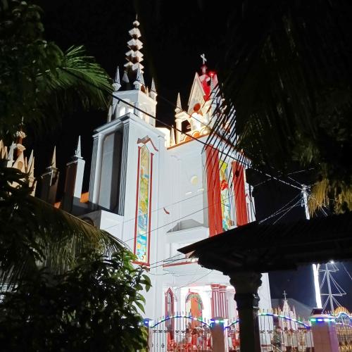 a white church with a steeple at night at Bunaken 18 Diving Resort and Cafe in Bunaken