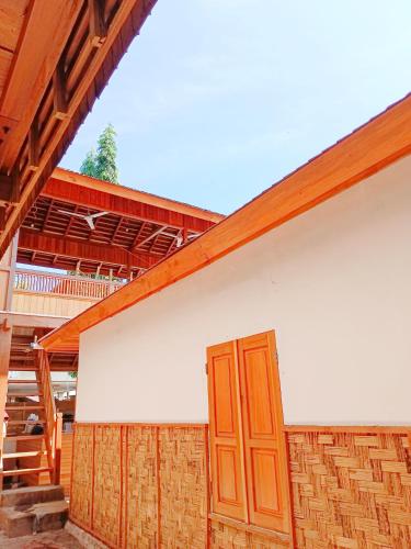 a building with a wooden door on the side of it at Bunaken 18 Diving Resort and Cafe in Bunaken