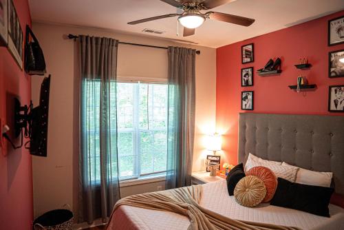 a bedroom with red walls and a bed with a window at Stylish Cozi Abode of Atlanta in Atlanta