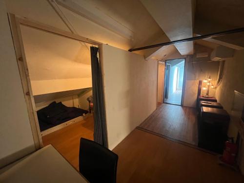 a view of a living room with a bed and a window at Guest House Ichiyama Shukuba in Matsumoto