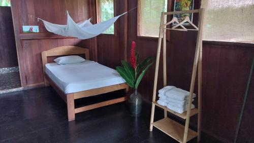 a room with a bed and a swing at River Point Hostel in Puerto Maldonado