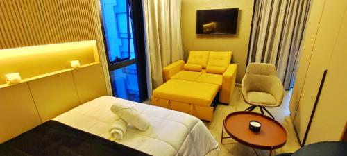a hotel room with a bed and a chair at Republica del Salvador Coliving Ecuador XOE in Quito
