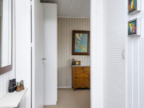 a hallway with a wooden dresser in a room at Holiday home Juelsminde XV in Sønderby