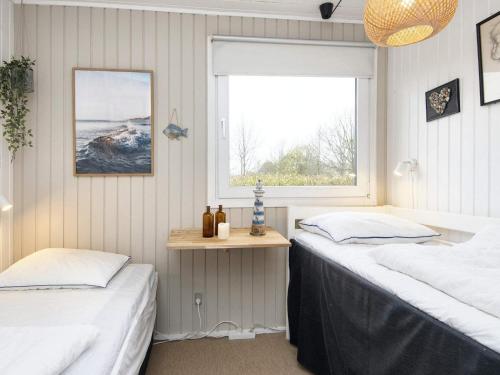 a bedroom with two beds and a window at Holiday home Juelsminde XV in Sønderby