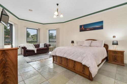 a bedroom with a bed and a living room at Villa Di Morcone By The Bay in Rye