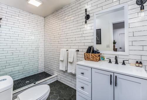 a white bathroom with a toilet and a sink at Peyton's Luxury Suite in Oakhurst