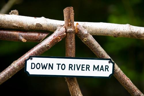 a sign that says down to river marrar at The Mar Huts - The Lomond Hut in Drymen