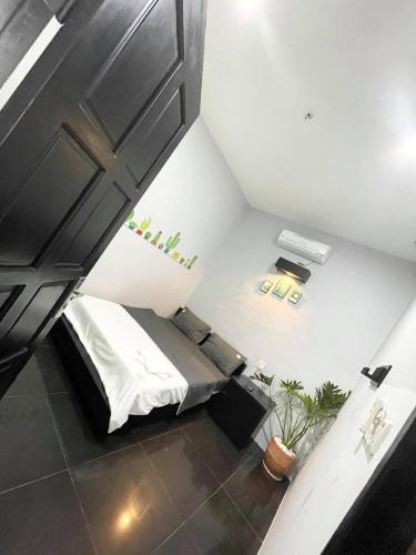 an attic room with a bed and a ceiling at Evergreen Tree Homestay in Phan Thiet