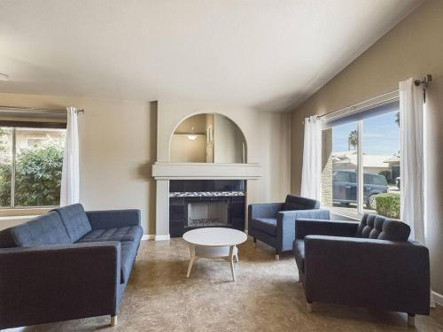 a living room with blue furniture and a fireplace at Family Fun w POOL: 3BR Chandler's Heart in Chandler