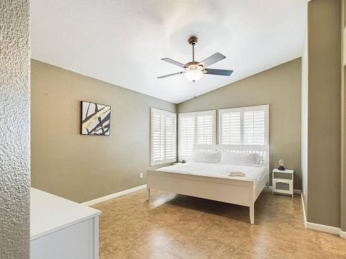 a bedroom with a bed and a ceiling fan at Family Fun w POOL: 3BR Chandler's Heart in Chandler