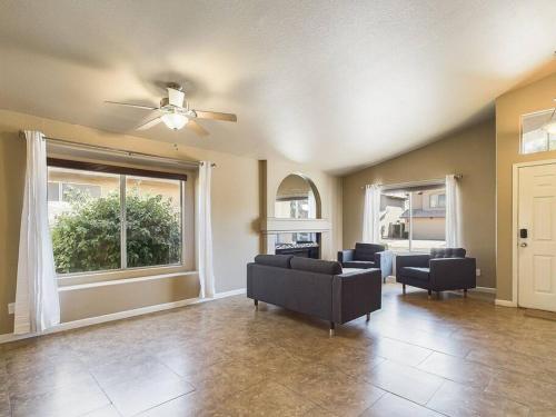 a living room with a couch and a window at Family Fun w POOL: 3BR Chandler's Heart in Chandler
