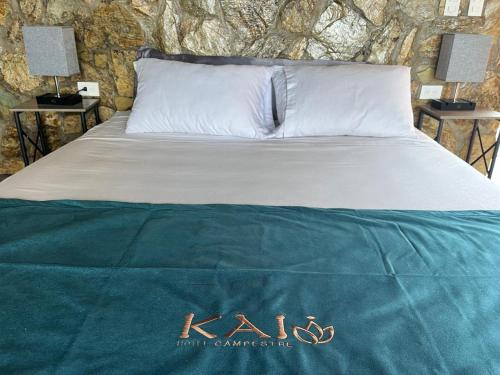 a bedroom with a bed with aigil sign on it at Kai Hotel Campestre in Calarcá