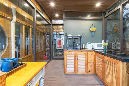 a kitchen with wooden cabinets and a counter top at Chiburo Home Đà Lạt in Da Lat