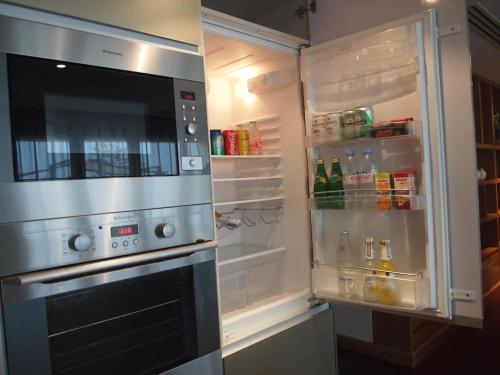 a refrigerator with its door open with its door at The Nchantra Beachfront Resort in Phuket Town