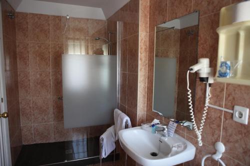 a bathroom with a sink and a mirror at Gran Hotel Balneario de Liérganes in Liérganes
