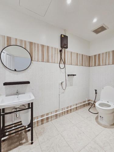 a bathroom with a toilet and a sink and a mirror at Casa Maya House in Phi Phi Islands