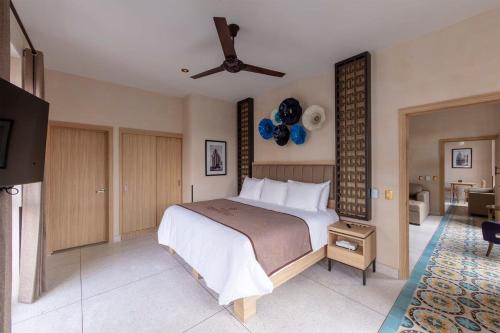 a bedroom with a bed and a ceiling fan at Master suite steps from Bellas artes in Mexico City