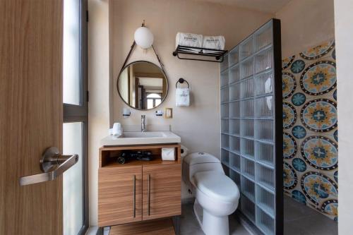 a bathroom with a toilet and a sink and a mirror at Master suite steps from Bellas artes in Mexico City