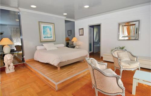 a bedroom with a bed and a table and chairs at Lovely Home In Aubais With Wifi in Aubais