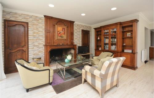 a living room with two chairs and a fireplace at Lovely Home In Aubais With Wifi in Aubais