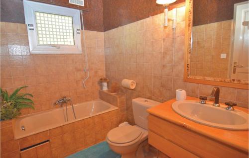 a bathroom with a tub and a toilet and a sink at Lovely Home In Aubais With Wifi in Aubais