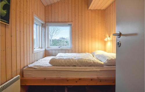 a bed in a room with a window at Søhus in Tranekær