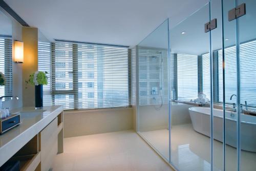 a bathroom with a tub and a sink at Marco Polo Wuhan in Wuhan