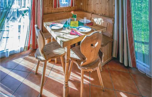 a wooden table with two chairs in a room at Awesome Home In St,georgen A,kreischb, With 1 Bedrooms, Internet And Indoor Swimming Pool in Sankt Lorenzen ob Murau