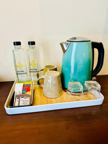 a tray with a teapot and other items on a table at Limeshine - Airport Transit Hotels & Residences in Katunayake
