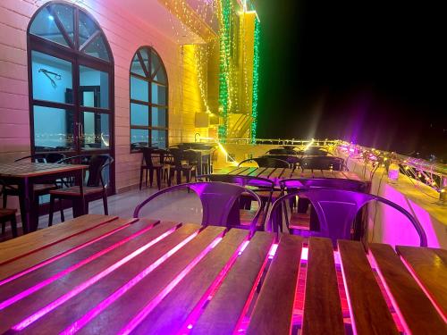 a nightclub with a table and purple lights at Nath Palace in Varanasi