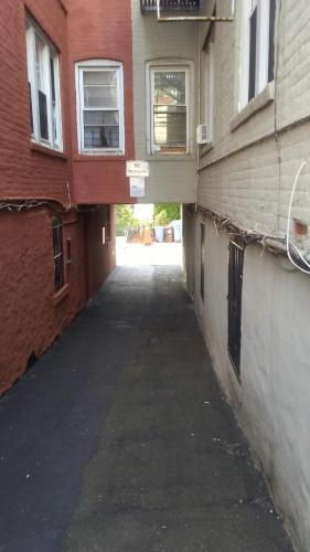 an empty alley way between two buildings with windows at Furman Apartments in Wakefield