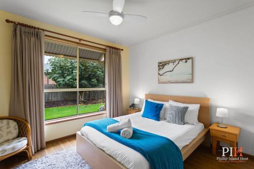 a bedroom with a large bed and a window at Charming 3-Bedroom Retreat in Cowes