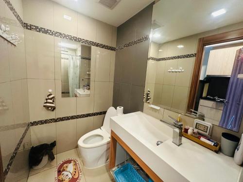 a bathroom with a sink and a toilet and a mirror at Laguna Beach resort 2-projector loft room in Jomtien Beach