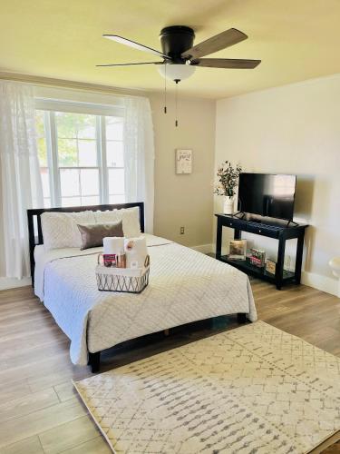 a bedroom with a bed with a fan and a piano at Little Hollywood Suite @ The Historic Kanab Inn in Kanab