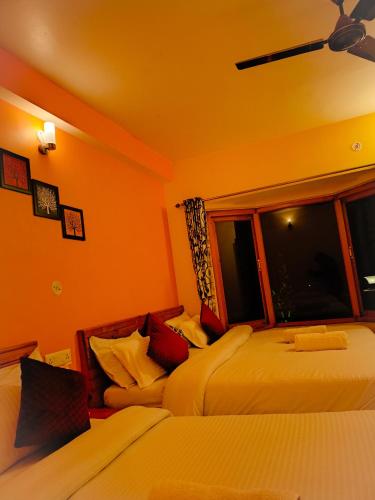 a bedroom with two beds and a window at JMT Eco-Binsar by StayApart in Panuānaula