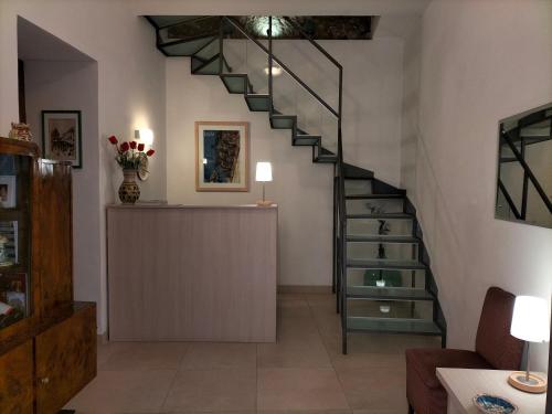 a living room with a spiral staircase and a counter at San Filippo Neri - CAMERE in Ragusa